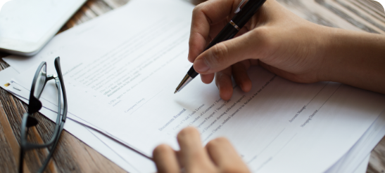 businessman-examining-papers-at-table
