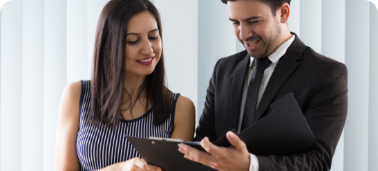 smiling-confident-colleagues-examining-document-together